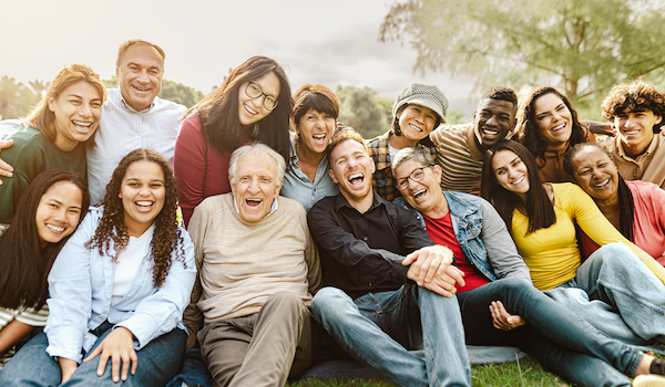 A group of people sitting and smiling.
